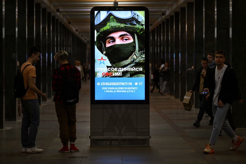 An advertising screen  on a metro station platform in Moscow promotes contract military service in the Russian army. Photograph: Natalia Kolesnikova/AFP via Getty Images