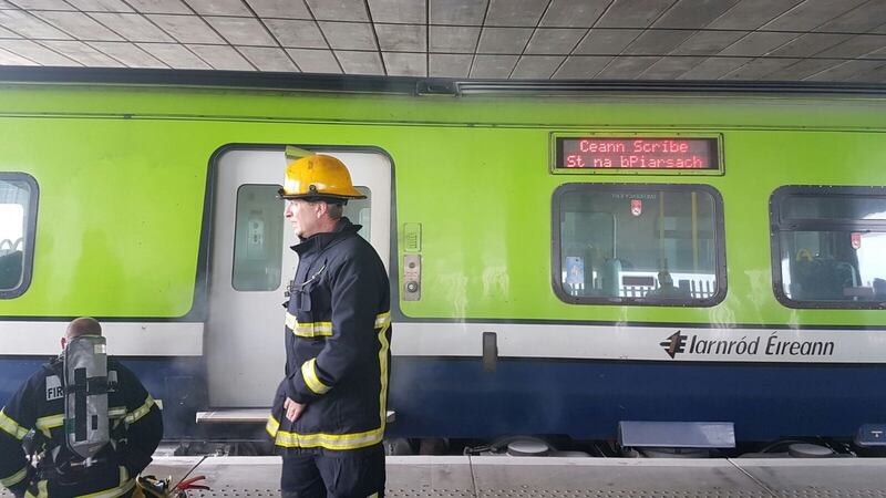 Officers from the Dublin fire brigade attend a fire on a train at Clongriffin station on Tuesday morning. Photograph: Paddy Logue/The Irish Times
