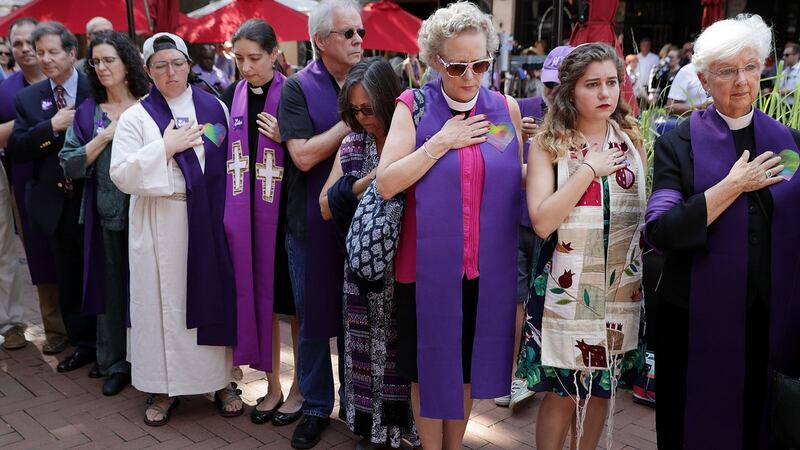 Clergy observe a moment of silence during the memorial service for Heather Heyer outside the Paramount Theater in Charlottesville, Virginia. Photograph: Chip Somodevilla/Getty Images