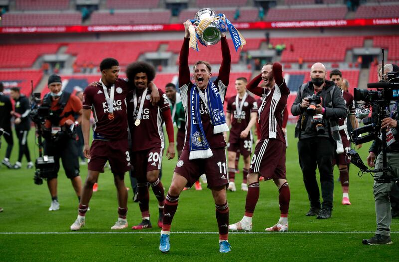 Leicester's Marc Albrighton holds aloft the FA Cup after the 2021 final, which was played in front of a reduced crowd because Covid-19 restrictions had been only partly lifted. Photograph: Matt Childs/Pool/Getty Images