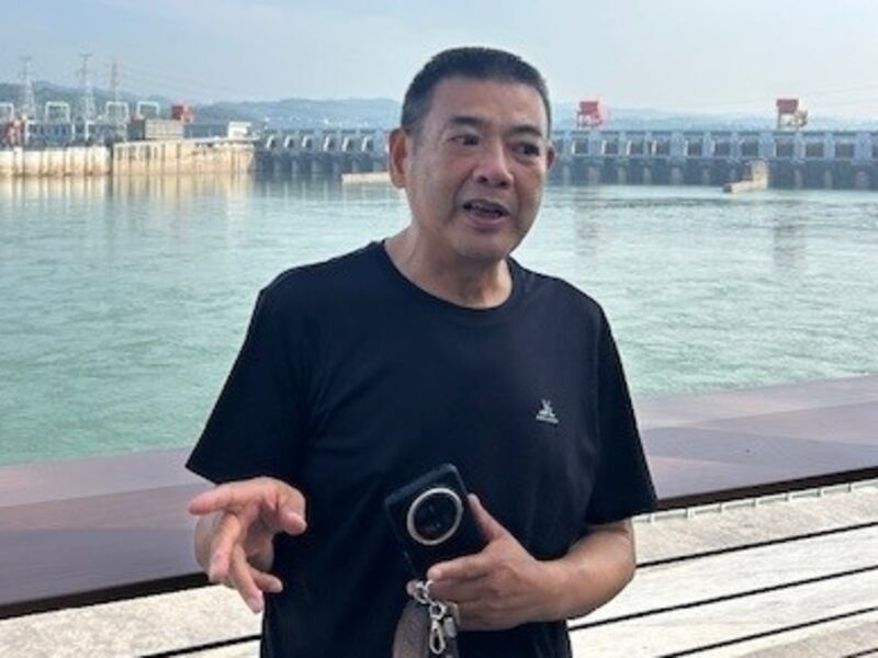 Yang Jin, an amateur photographer of finless porpoises, on a bank of the Yangtze River