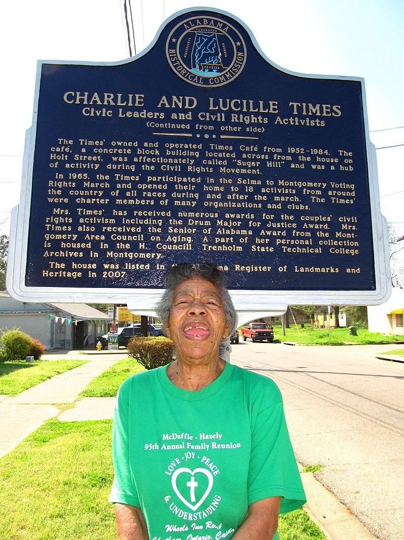 Lucille Times outside her home where the state placed historic markers in front in 2007