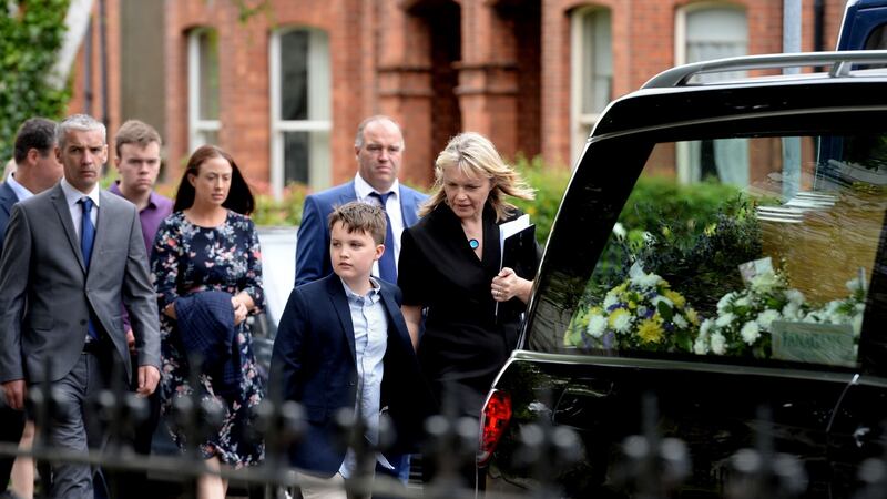 Sinead McSweeney and her son Séamus follow the remains of husband and father Noel Whelan at the Church of the Holy Name in Ranelagh. Photograph: Alan Betson/The Irish Times