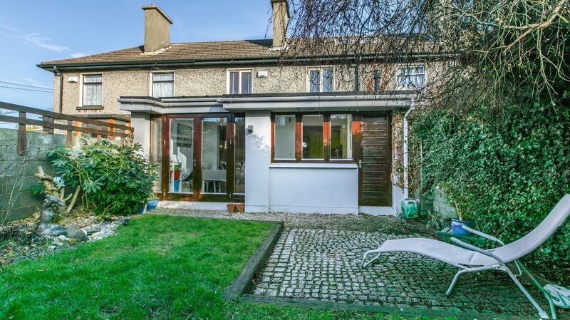 The small but fairly private back garden has a lawn, patio area and lots of mature shrubs