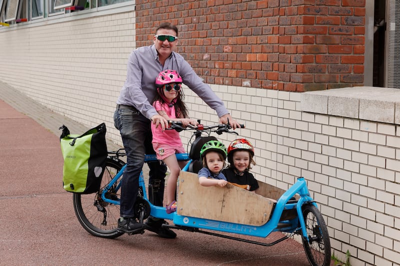 Eoin Hardiman from Ranelagh with his children Hannah (5), Luca (2) and Adrian (3) in the cargo bike they use to go to school, at Blackrock, Dublin. Photograph: Alan Betson