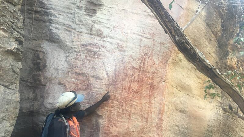 Roland Burrunali, a member of the local Bininj community, shows Aboriginal artwork
