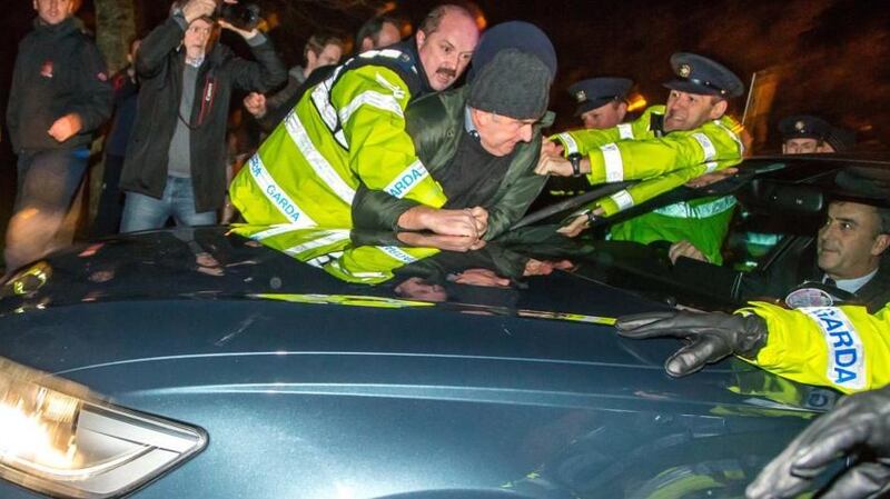 Gardaí attempt to remove a protestor from the bonnet of Enda Kenny’s car as it arrives at the Sligo Park Hotel. Photograph: James Connolly/PicSell