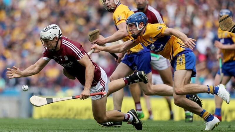 Galway’s Daithi Burke is challenged by Clare’s Shane O’Donnell. Tommy Dickson/Inpho