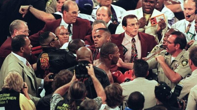 Mike Tyson confronts police officers after he was disqualified for biting Evander Holyfield. Photograph: Mike Nelson/Getty/AFP