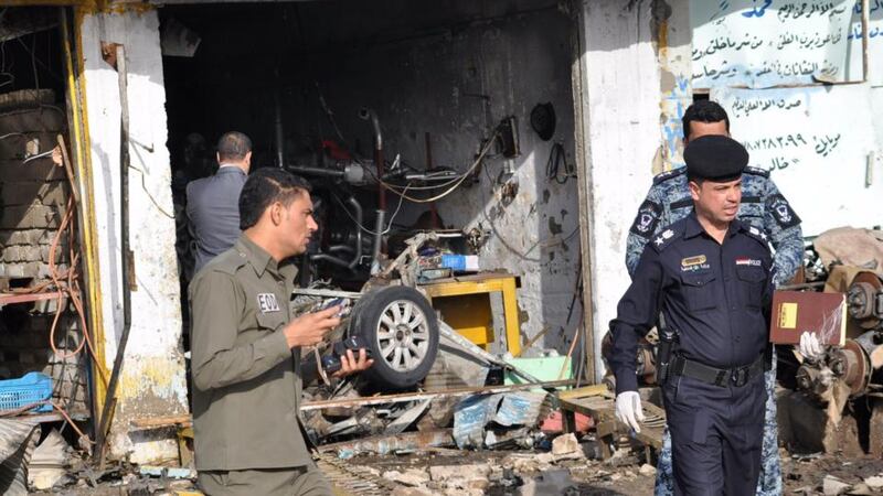 Iraqi security forces personnel inspect the site of a car bomb attack in Nassiriya, 300km south of Baghdad. Photograph: Reuters