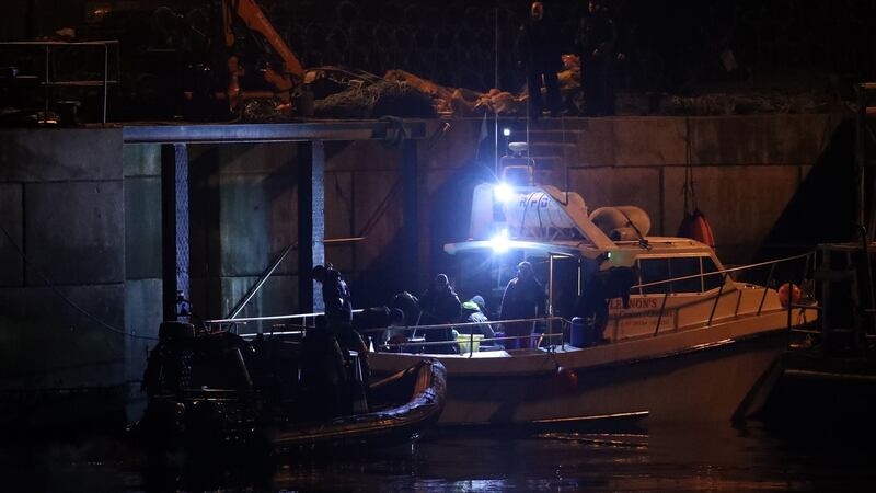 Members of the search-and-rescue team return to the quayside at Blacksod, Co Mayo,  as dive teams continue searching the wreckage of an Irish Coast Guard helicopter.  Photograph: Chris Radburn/PA Wire