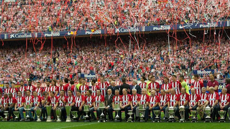 Former and current Club Atletico de Madrid players pose in front of their trophies at the club’s last match at Vicente Calderon stadium. Photograph: Getty Images
