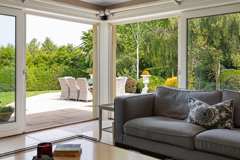 Two sets of custom doors open to the rear garden