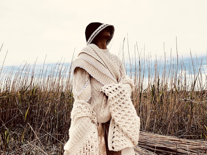 Hand-crochet coat with rib and wave stitch, hand-knitted Aran jumper with hand-crochet trim in ivory Donegal yarn, €1,295.