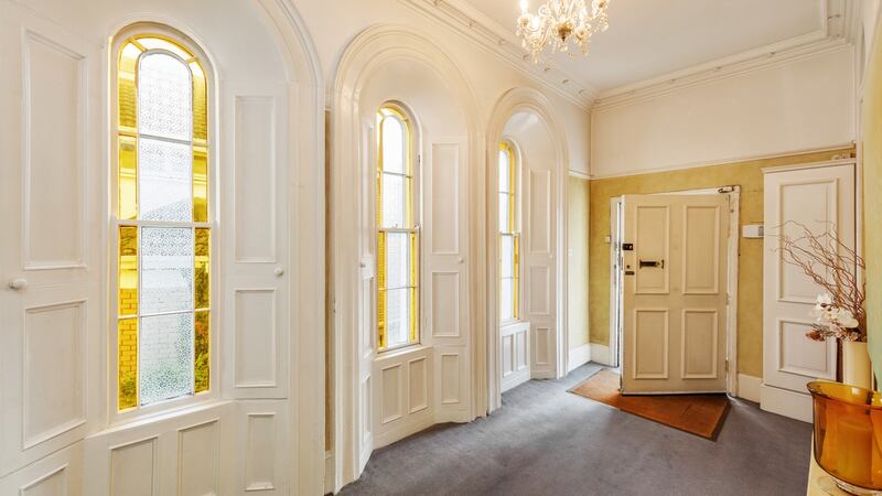 The hallway with the three tall round-head windows.