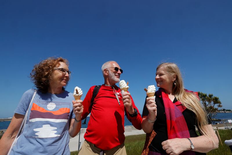 Hella and Tony Stieber and Annette Kungagon from Booterstown enjoy their 99s along the seafront at Dún Laoghaire. Photograph: Alan Betson
