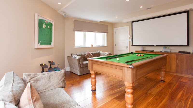 A polished walnut floor runs throughout most of the ground floor and there’s recessed lighting everywhere