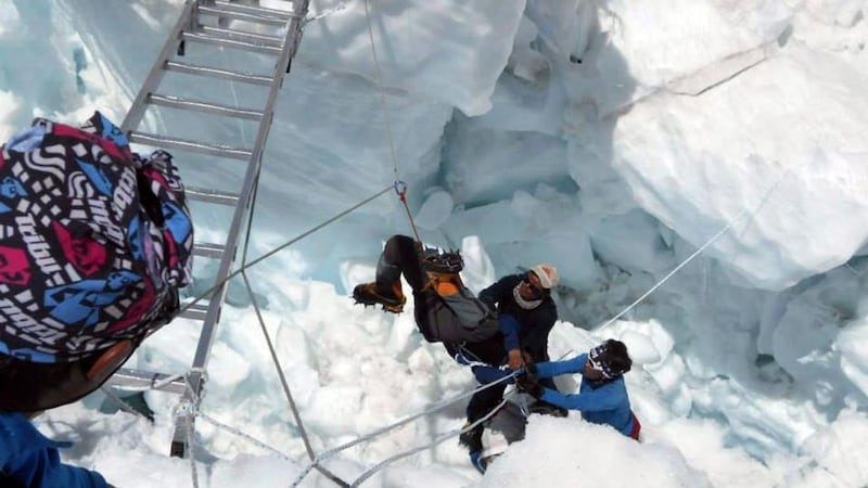 Nepalese mountain rescue workers lifting an injured climber after the avalanche. Photograph: EPA