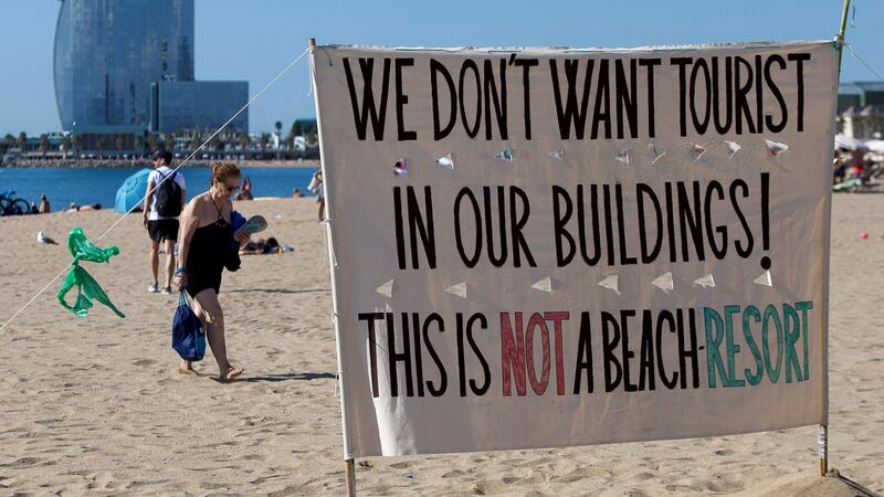 A sign with a mass tourism protest message is seen in Barcelona, Spain August 12, 2017. Reuters/Albert Salame