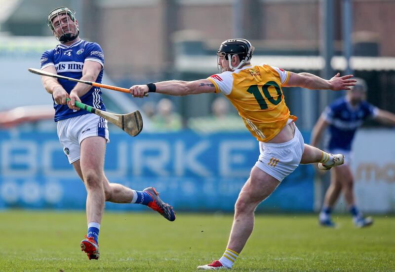 Antrim’s Ryan McCambridge blocks a shot from Laois's Paddy Purcell. Photograph: Leah Scholes/Inpho