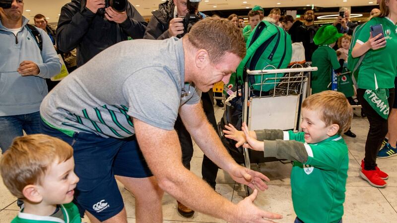 Ireland’s Seán Cronin is welcomed back into Dublin Airport by his twin boys Cillian and Finn. Photograph: Morgan Treacy/Inpho
