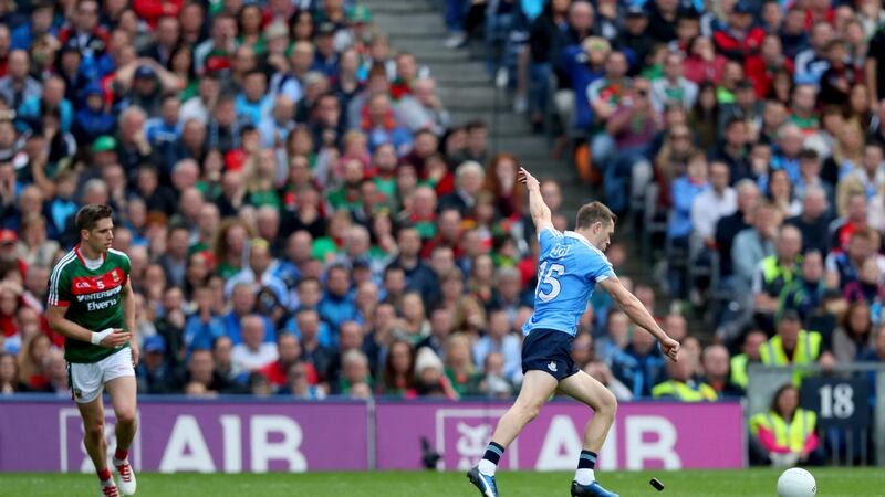 Mayo's Lee Keegan throwing his GPS tracker at Dean Rock as he kicks the winning point in the 2017 All-Ireland final. Photograph: James Crombie/Inpho