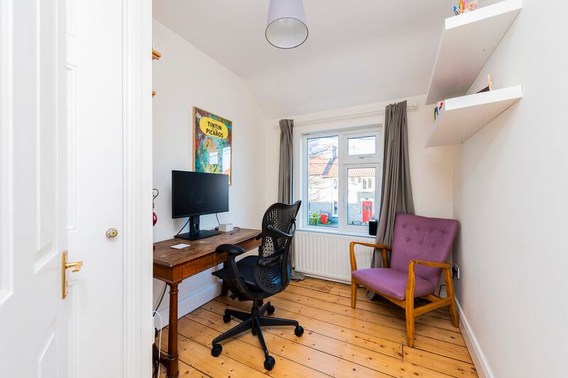 Spare bedroom in use as a home office.