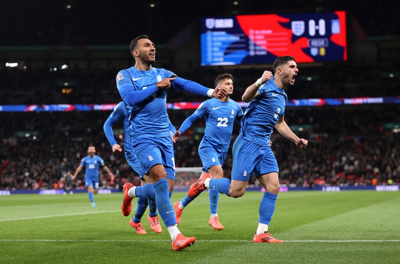 Vangelis Pavlidis of Greece gestures towards his black armband in honour of the passing of George Baldock after scoring against England, Photograph: Julian Finney/Getty Images