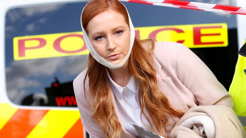 An injured woman is led away after an incident at Parsons Green.