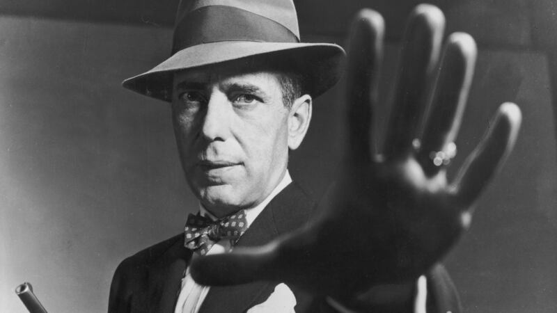 1951: American actor Humphrey Bogart carrying a gun and holding out his hand, in a still from director Bretaigne Windust’s film, ‘The Enforcer’. Photograph: American Stock/Getty Images