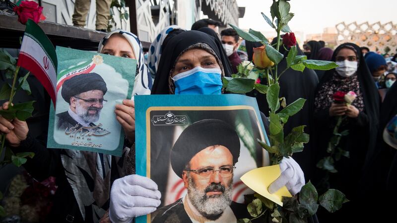 Supporters hold photographs of Ebrahim Raisi, Iran’s incoming president, in Imam Hossein Square, Tehran. Photograph: Ali Mohammadi/Bloomberg