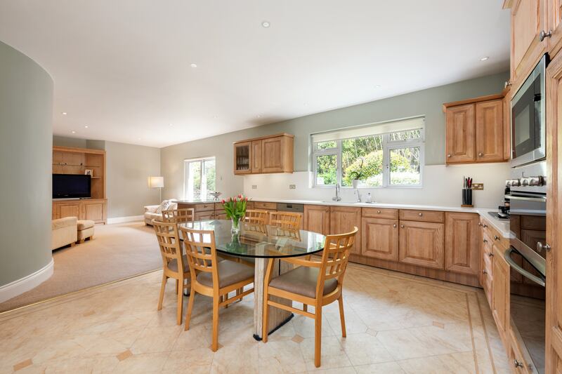 The expansive, eat-in kitchen lies to the back of the house. Facing east, it has silestone countertops, handsome oak cabinets and Miele appliances.