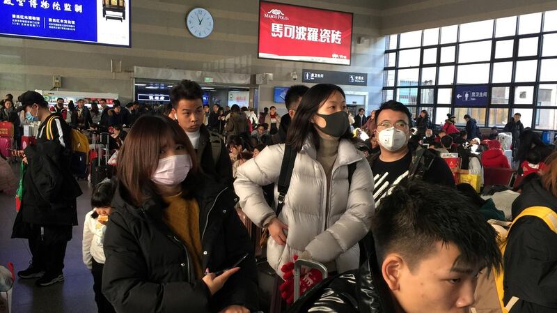 Passengers wearing masks wait to board trains at the Beijing West Railway Station, in Beijing, China, on Monday. Photograph: Reuters