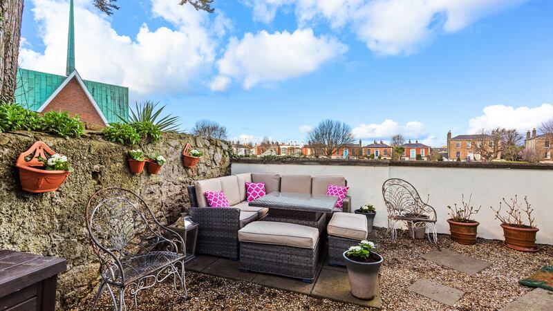 To the rear  is a gravelled patio backing on to  the  playing fields of St Louis  secondary school.