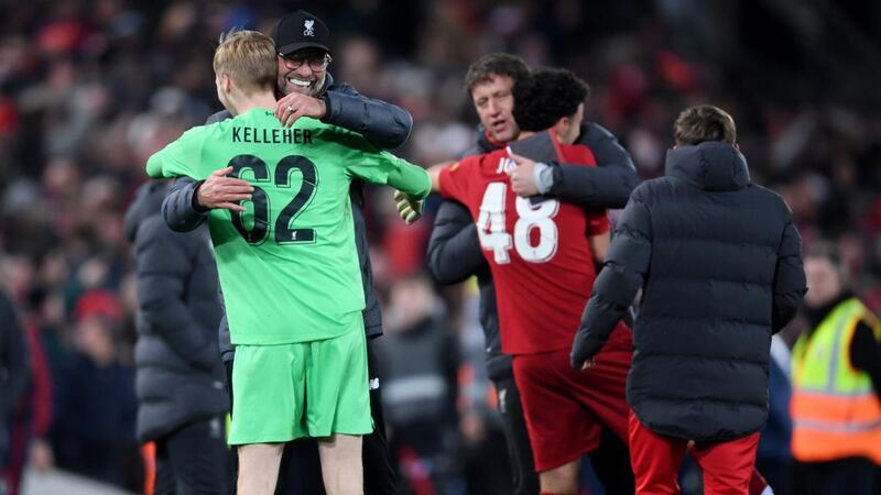 Liverpool manager Jürgen Klopp hugs goalkeeper Caoimhín Kelleher after the penalty shootout. Photograph:   Laurence Griffiths/Getty Images