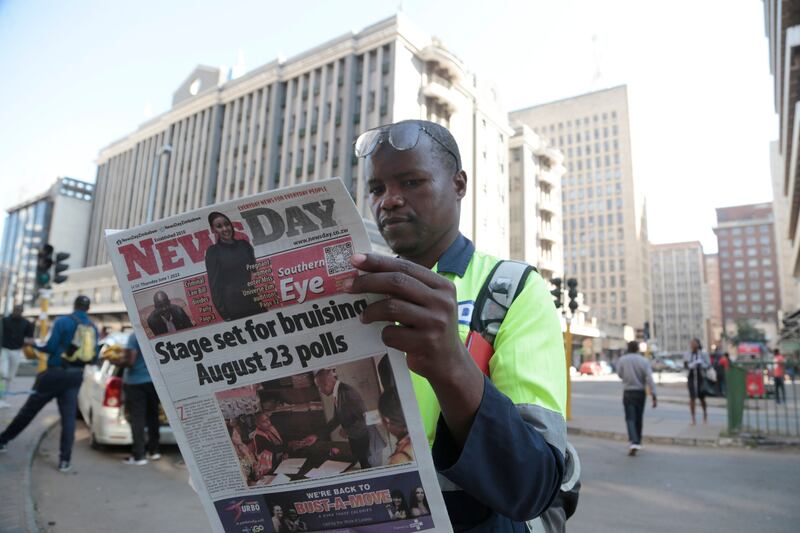 A man reads a daily newspaper in Harare, Zimbabwe. Photograph: Aaron Ufumeli/EPA-EFE
