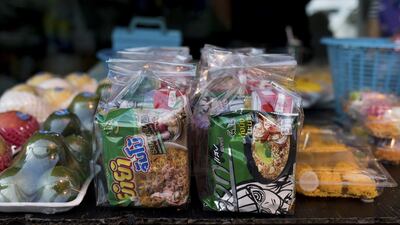 Prepackaged food, sold to be given to monks. “Soft drinks, boxed juice, sweet snacks, plus many of the foods are store-bought,” a nutrition professor says, describing some typical donations.