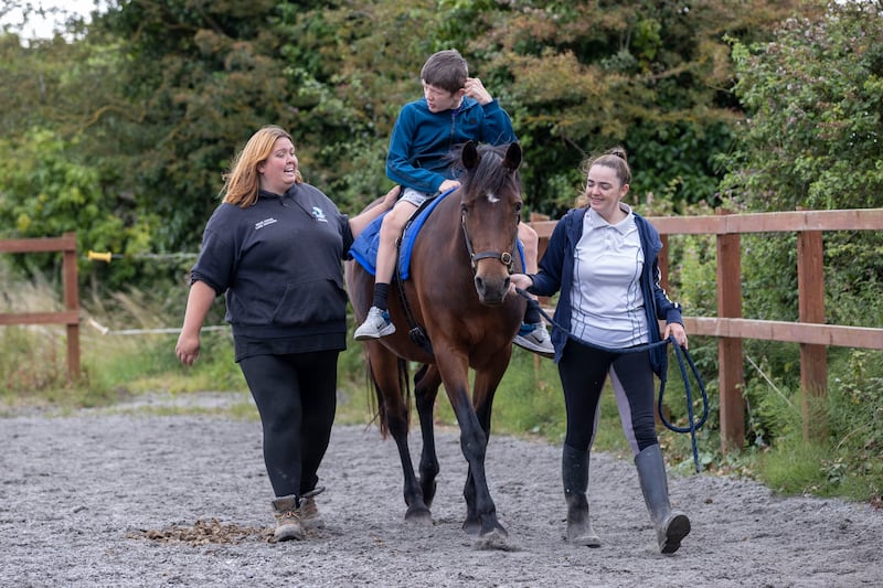 Georgia Lillis and Aoife Weldon with Rogan Spencer on Rosie the pony at the Royal Stables. Photograph: Tom Honan