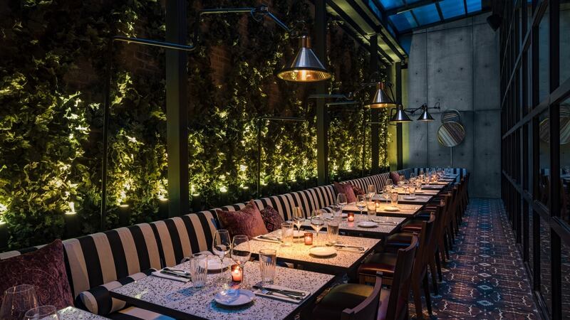 The Moxy Chelsea, in New York, designed by Yabu Pushelberg, uses chalk-striped fabric on a long line of seating to maximise capacity.