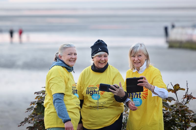 Sisters Sue, Phil and Anne Keegan from Ranelagh during Darkness into Light, Sandymount, Dublin. Photograph: Dara Mac Dónaill
