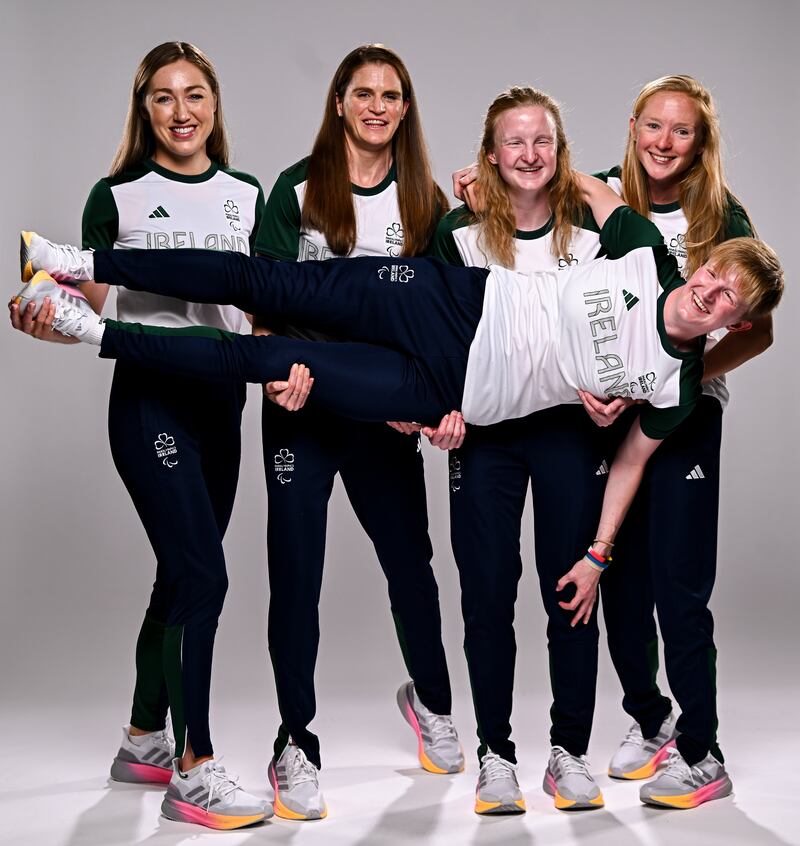 Ireland's para-triathletes and guides, from left, Eimear Nicholls, Catherine Sands, Judith MacCombe, and Cassie Cava as they hold Chloe MacCombe. Photograph: Harry Murphy/Sportsfile