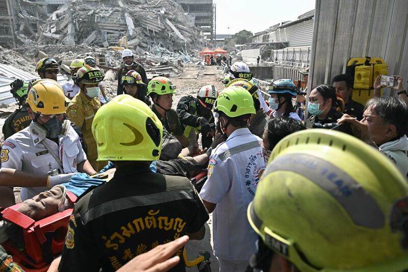 Myanmar and Thailand earthquake: An injured man is rescued at a construction site where a building collapsed in Bangkok. Photograph: Lillian Suwanrumpha/AFP