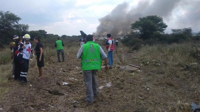 Rescue workers and firefighters  at the site where an Aeromexico airliner came down in a field near the airport of Durango, Mexico. Photograph: Civil Defense Office of Durango Photo/AP