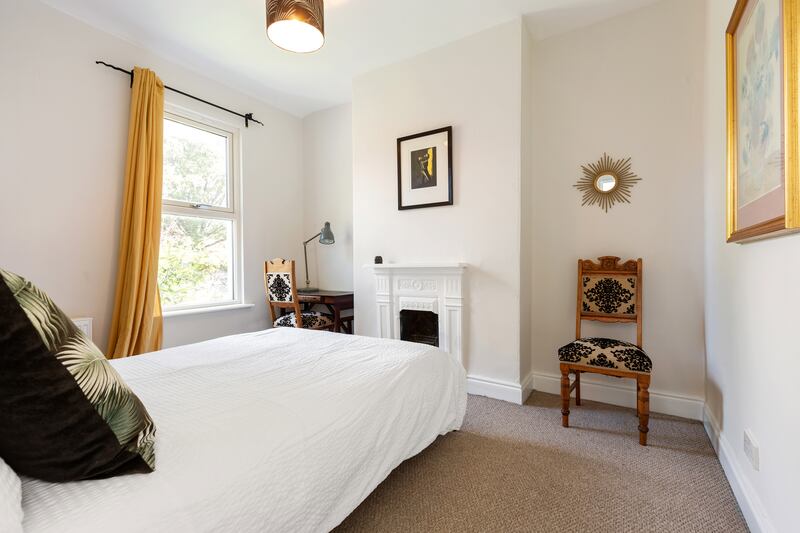 Second bedroom, with cast iron fireplace.