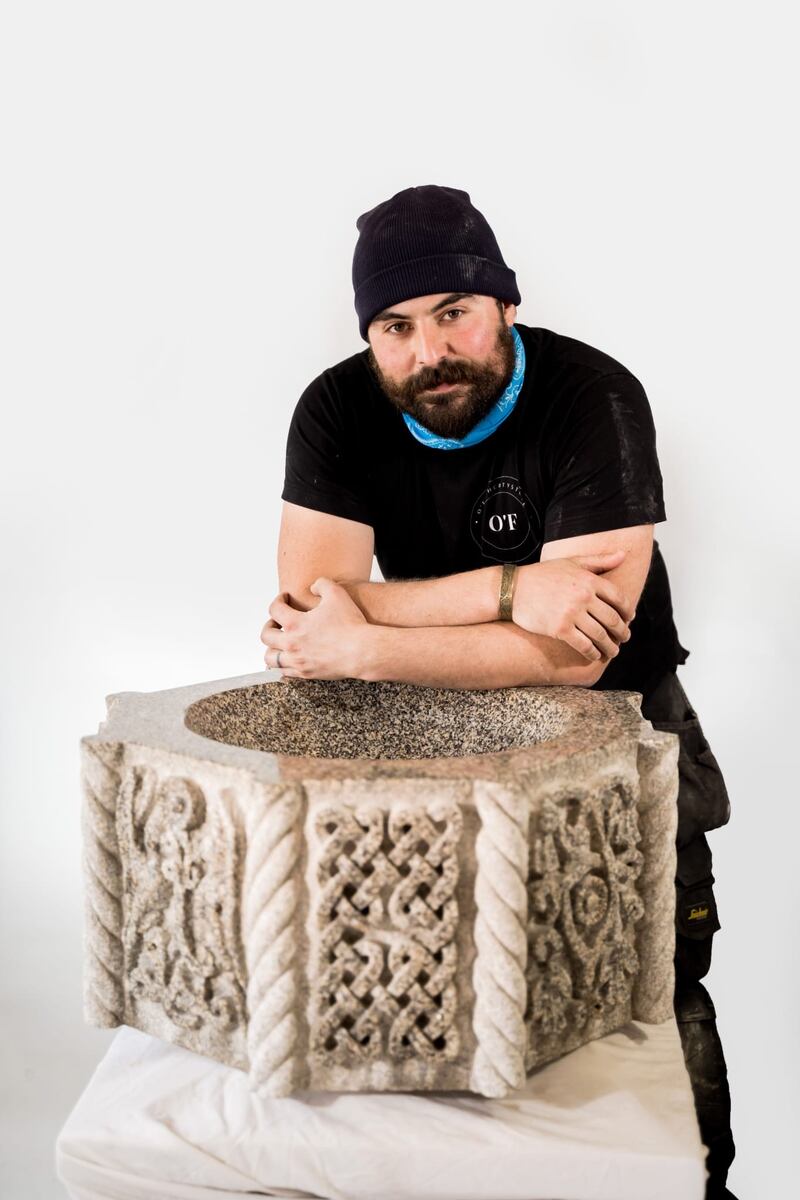 Killian in front of a baptism font