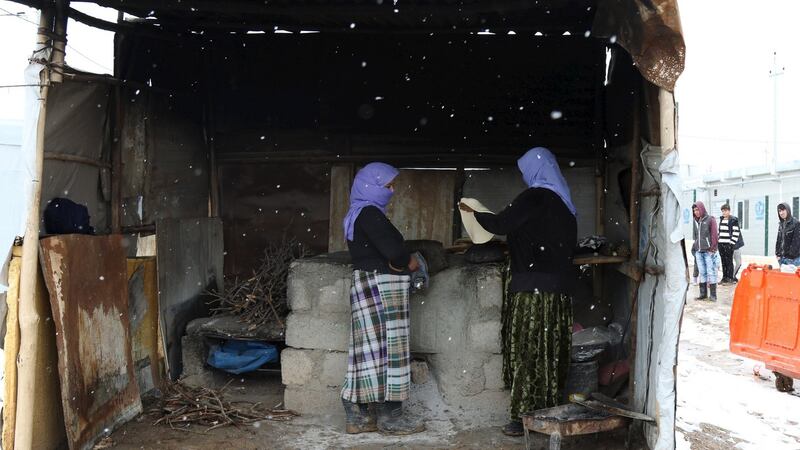 Displaced women from the minority Yazidi sect, fleeing violence in the Iraqi town of Sinjar, make bread at a refugee camp in Duhok province on January 2nd. Photograph: Ari Jalal/Reuters