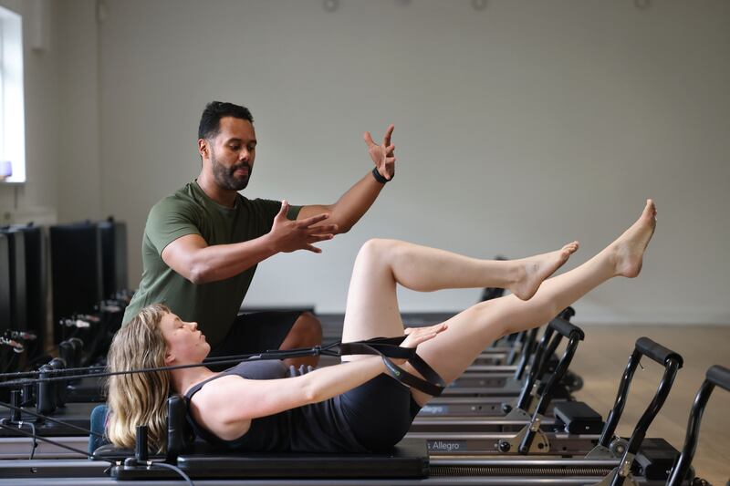 Roman Barahona, Pilates instructor, with Ruth O’Hora, at Yoga Hub. Photograph: Dara Mac Dónaill