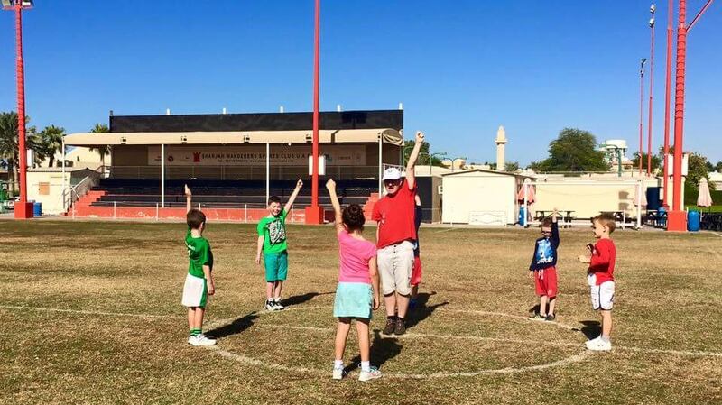 Pupils learning the basics of GAA at Gaelscoil UAE.