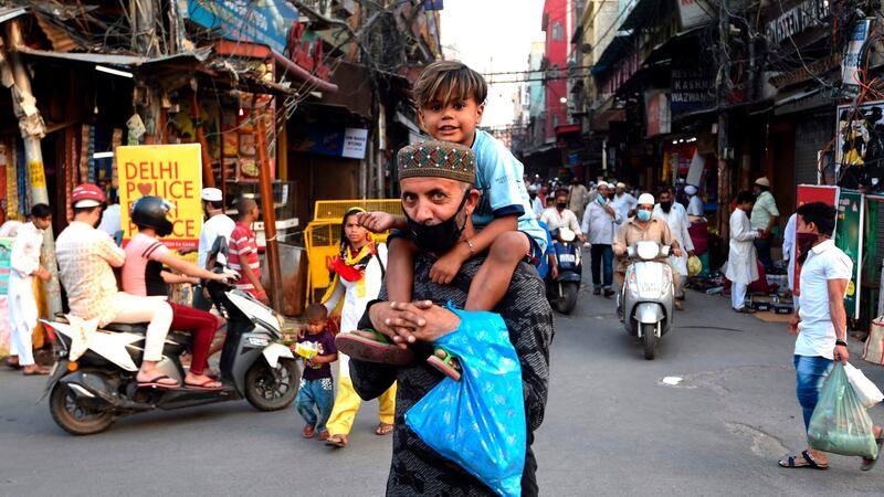 A man carries  his son on the last Friday of Ramadan in New Delhi. Photograph: Money Sharma/AFP via Getty Images