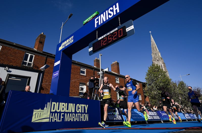Matthew Collins (left) and Ger Copeland share a small celebration as they cross the line. Photograph: Ramsey Cardy/Sportsfile